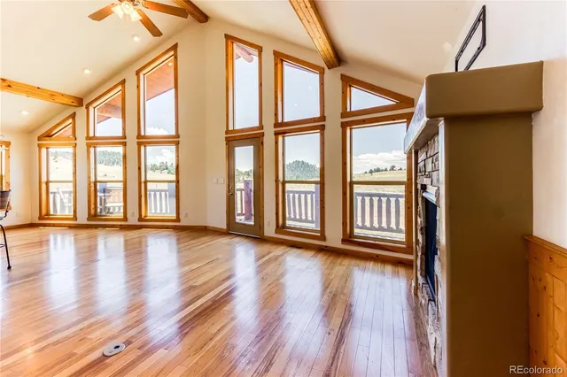 a kitchen with stainless steel appliances kitchen island granite countertop wooden floors and white cabinets
