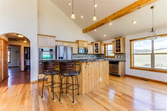 a kitchen with stainless steel appliances granite countertop a refrigerator sink and stove
