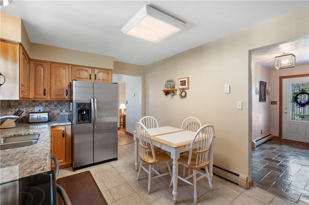 317 Madison Heights Road Madison, PA 15672 - Photo 11 of 32 a dining room with furniture and a refrigerator