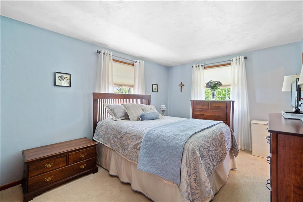 317 Madison Heights Road Madison, PA 15672 - Photo 18 of 32 a bedroom with a bed and a dresser next to a window