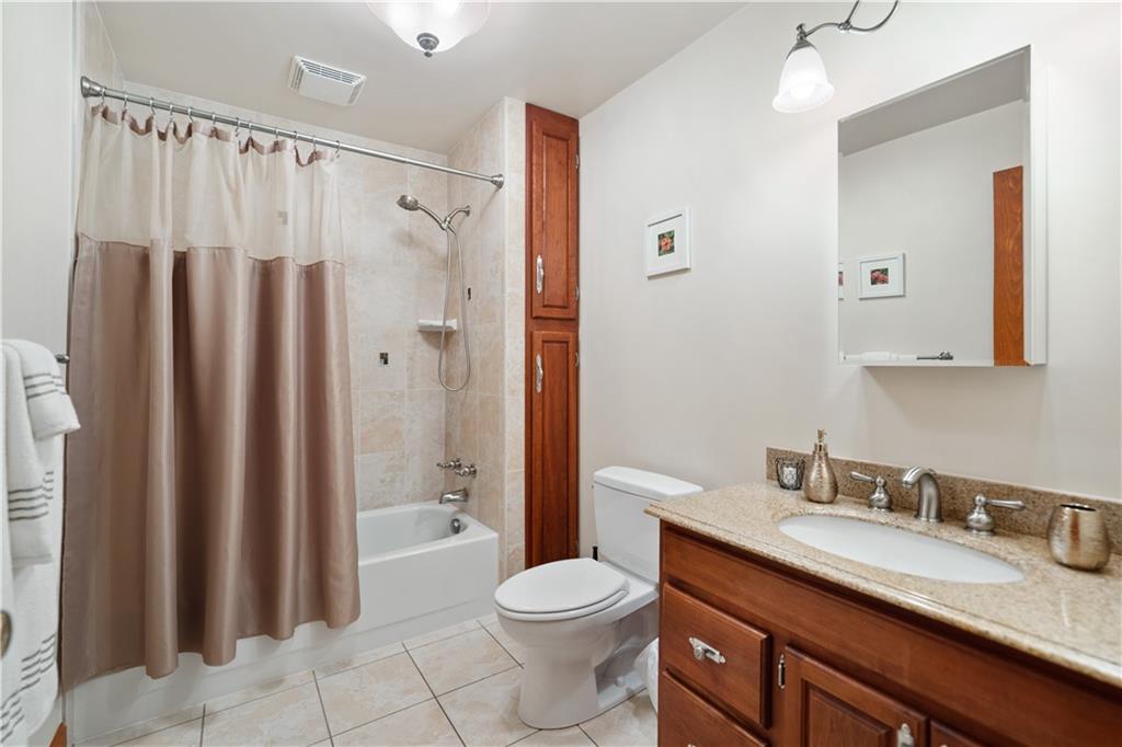317 Madison Heights Road Madison, PA 15672 - Photo 20 of 32 a bathroom with a granite countertop sink toilet and shower