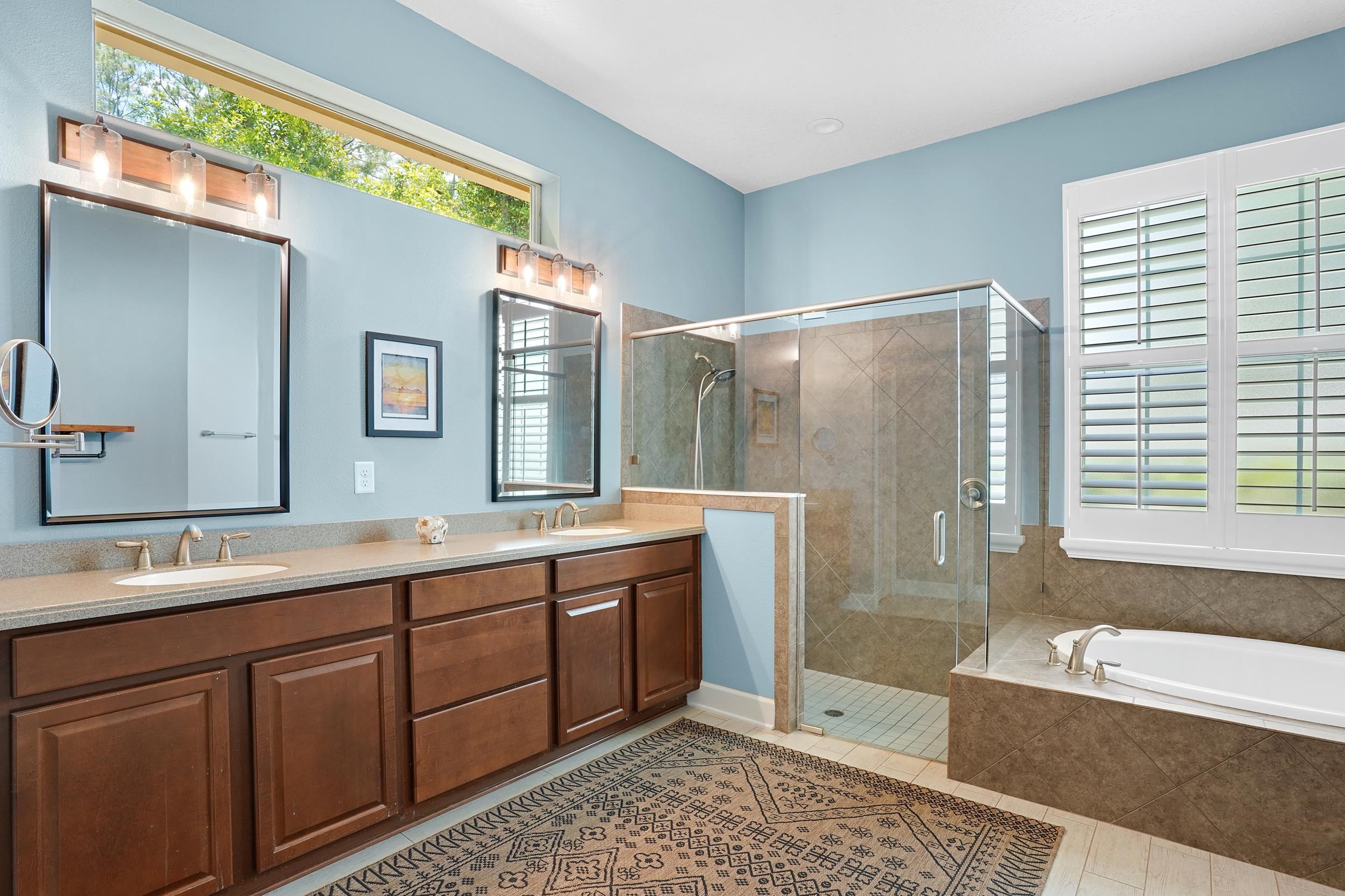 1308 Acorn Ridge Court St. Augustine, FL 32092 - Photo 22 of 47 a spacious bathroom with a double vanity sink large mirror and a bathtub