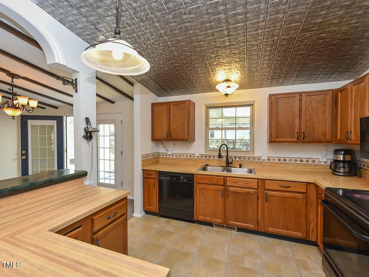 310 Electra Drive Cary, NC 27513 - Photo 11 of 45 a large kitchen with stainless steel appliances granite countertop a sink and dishwasher a stove with wooden floor