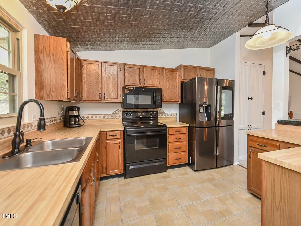 310 Electra Drive Cary, NC 27513 - Photo 12 of 45 a kitchen with granite countertop a refrigerator and a sink