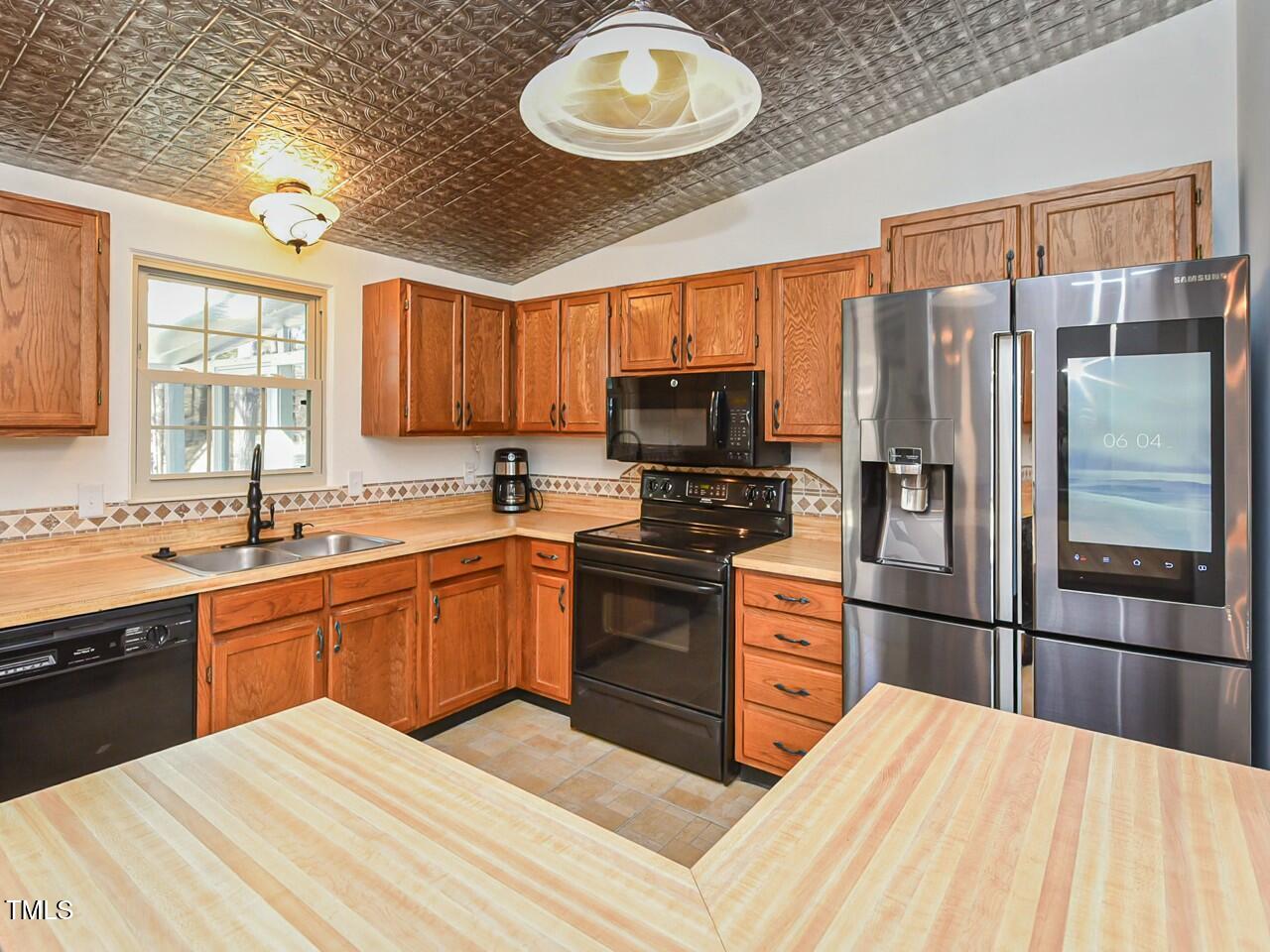 310 Electra Drive Cary, NC 27513 - Photo 13 of 45 a kitchen with stainless steel appliances granite countertop a refrigerator a sink dishwasher a stove top oven a sink and dishwasher