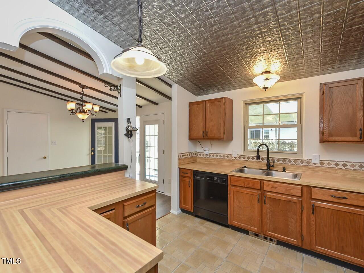 310 Electra Drive Cary, NC 27513 - Photo 14 of 45 a kitchen with stainless steel appliances granite countertop a sink dishwasher and white cabinets with wooden floor