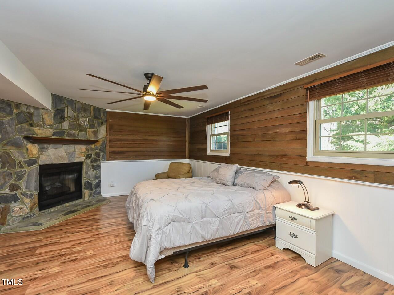 310 Electra Drive Cary, NC 27513 - Photo 17 of 45 a spacious bedroom with a bed and a fireplace