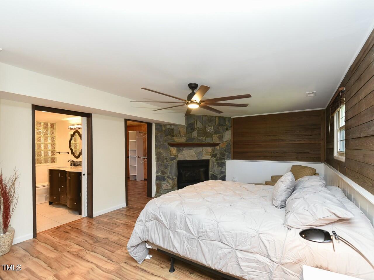310 Electra Drive Cary, NC 27513 - Photo 19 of 45 a bedroom with a bed and a chandelier