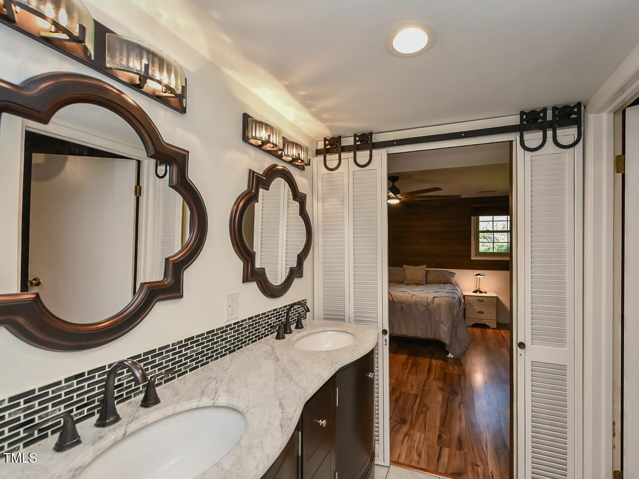 310 Electra Drive Cary, NC 27513 - Photo 20 of 45 a bathroom with a sink a mirror and a shower