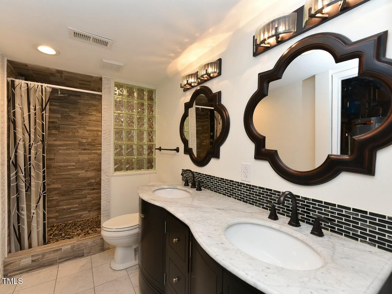310 Electra Drive Cary, NC 27513 - Photo 21 of 45 a bathroom with a sink mirror and toilet