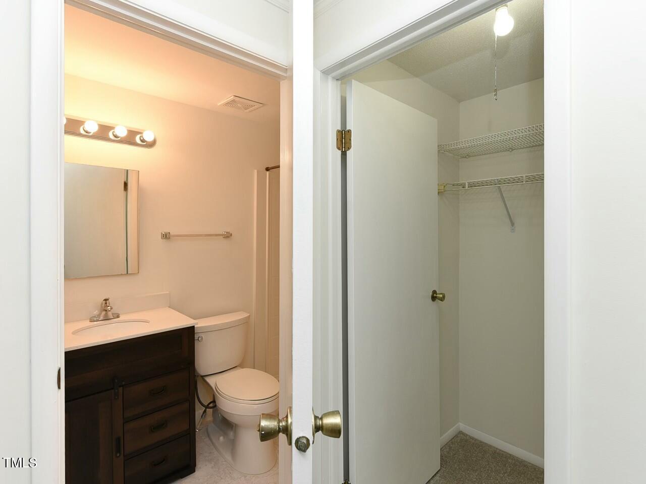 310 Electra Drive Cary, NC 27513 - Photo 29 of 45 a bathroom with a double vanity sink toilet mirror and shower