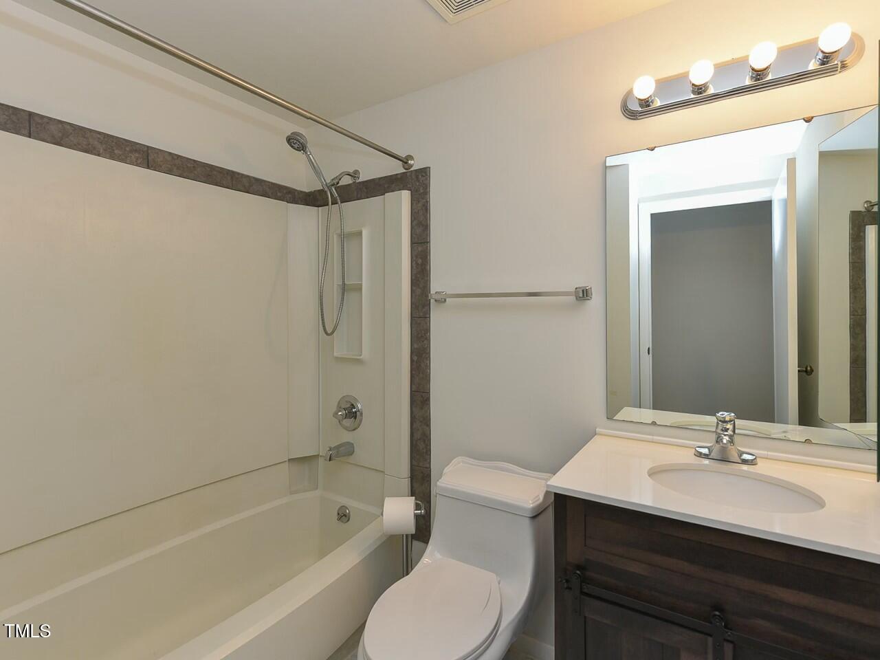 310 Electra Drive Cary, NC 27513 - Photo 33 of 45 a bathroom with a sink toilet a mirror and shower