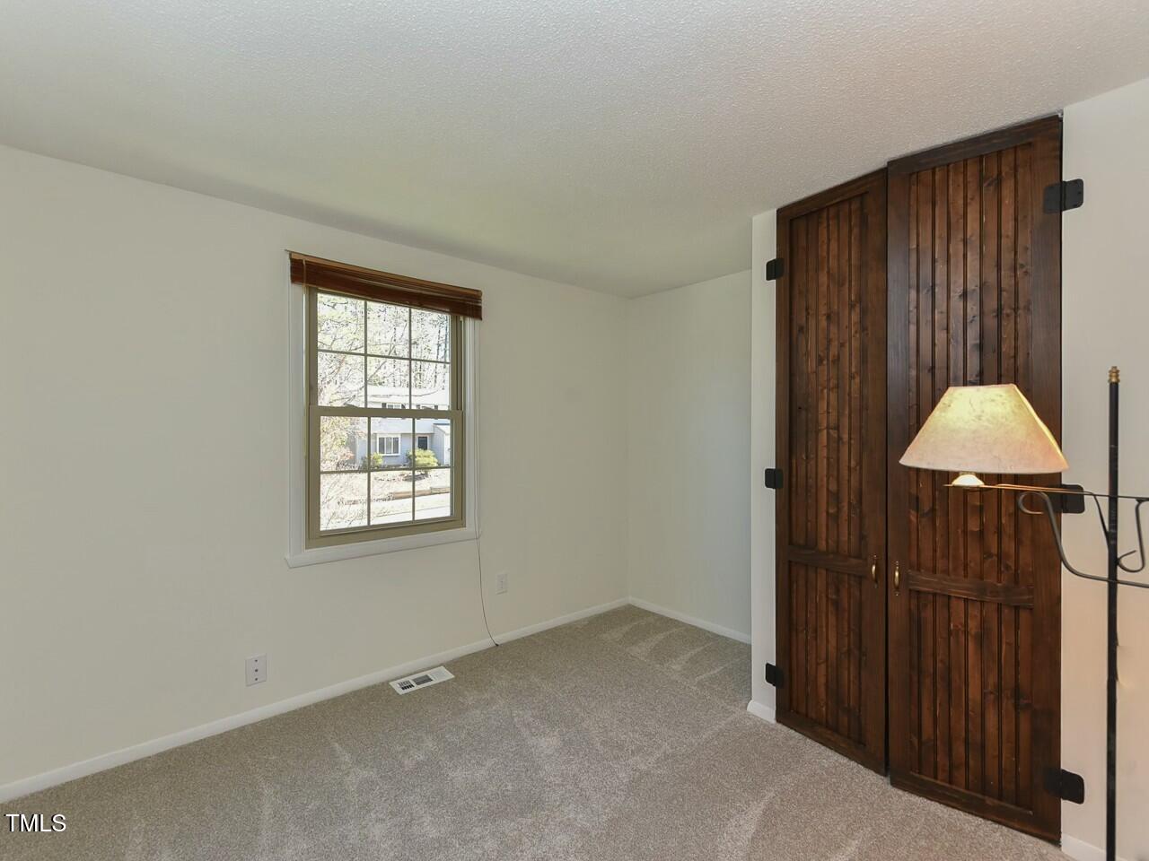 310 Electra Drive Cary, NC 27513 - Photo 34 of 45 an empty room with a window and a cabinet