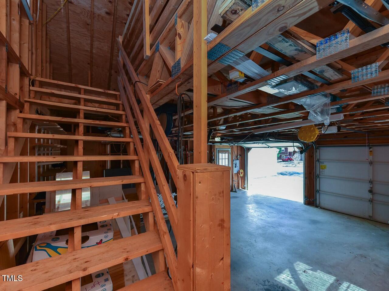 310 Electra Drive Cary, NC 27513 - Photo 43 of 45 a view of staircase with wooden floor and book shelf