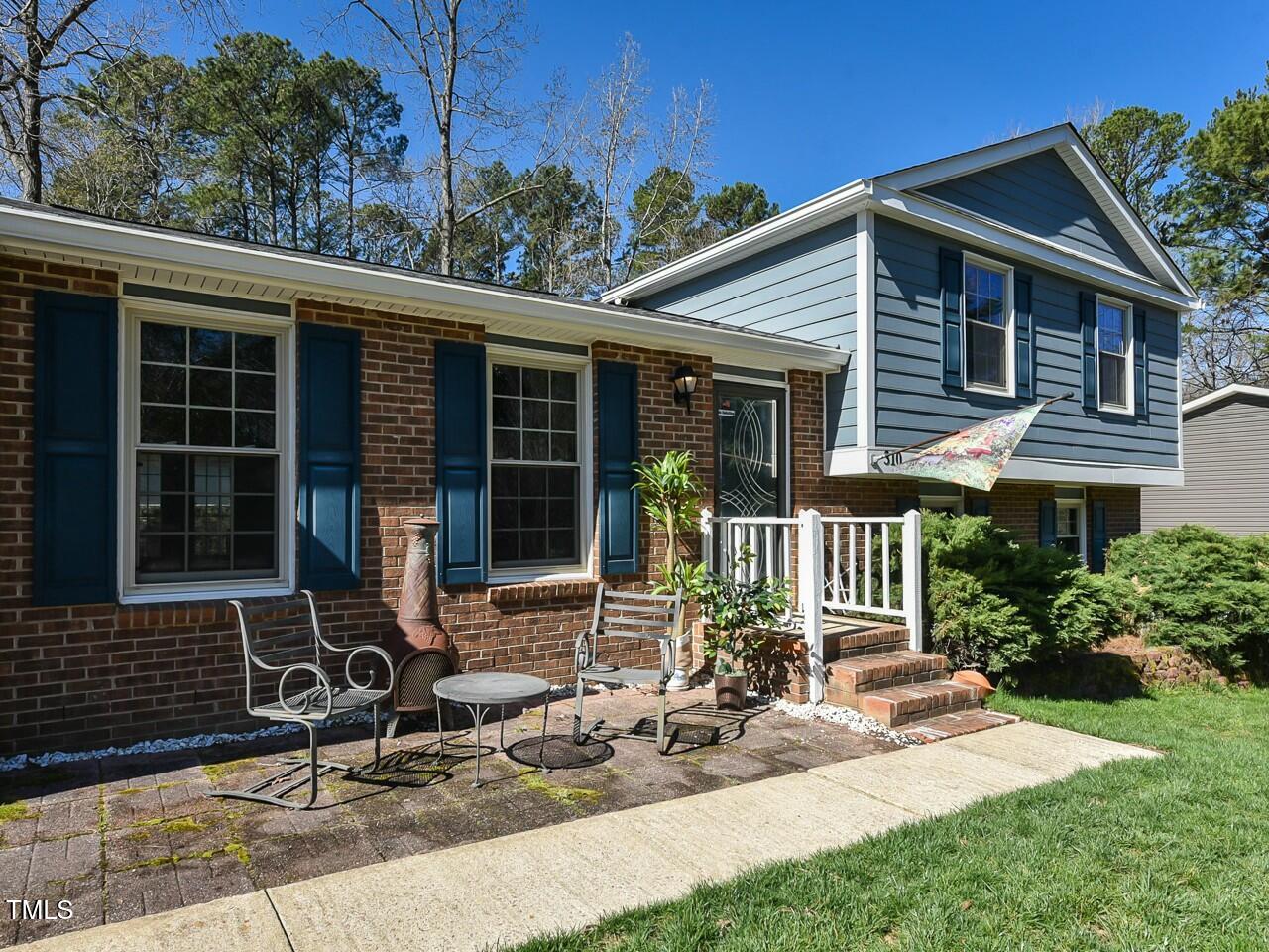 310 Electra Drive Cary, NC 27513 - Photo 5 of 45 a view of a house with backyard sitting area and garden