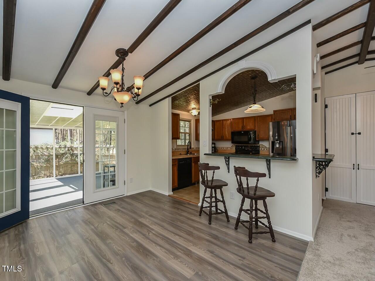 310 Electra Drive Cary, NC 27513 - Photo 9 of 45 a view of a dining room with furniture window and wooden floor