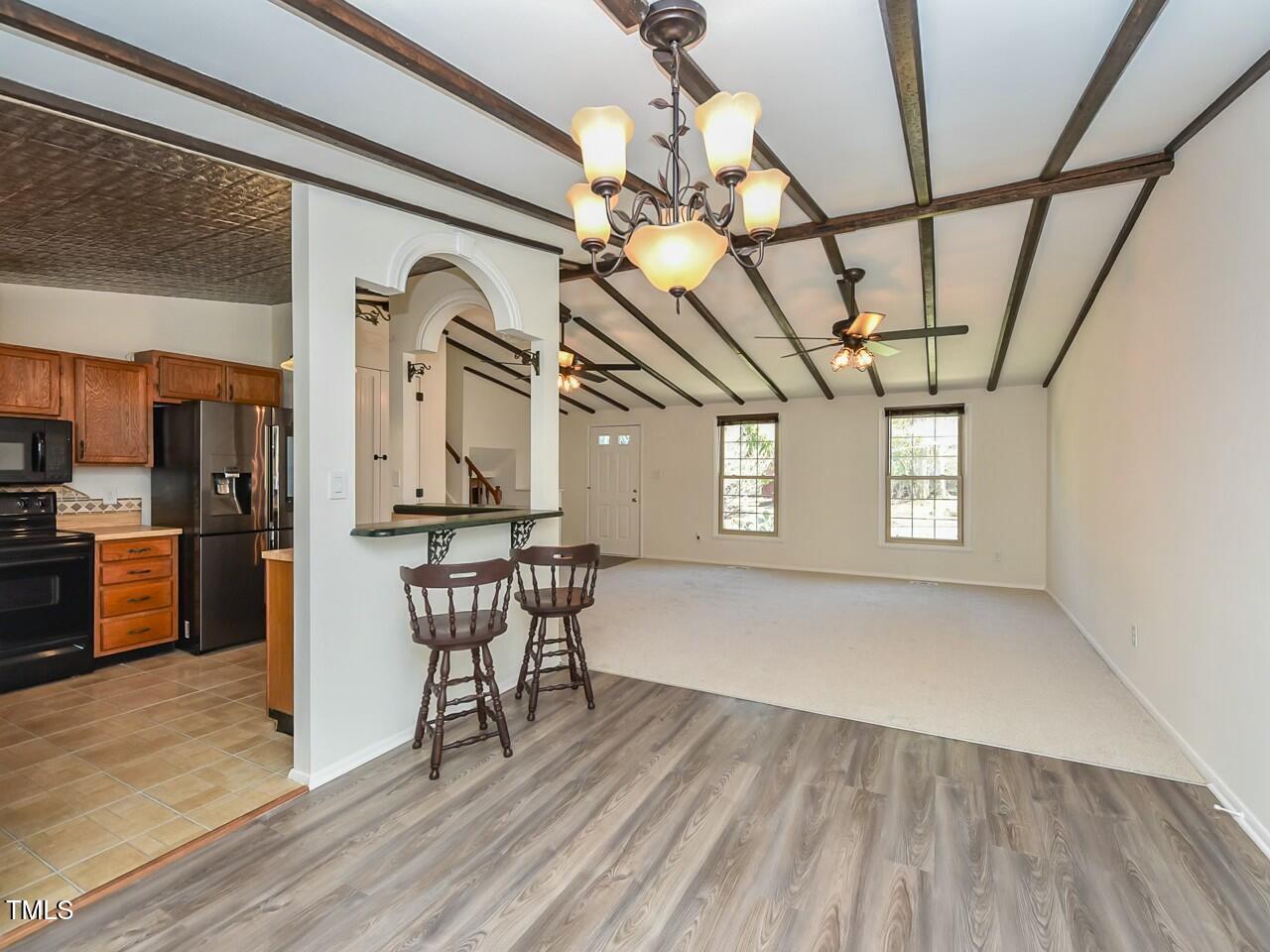 310 Electra Drive Cary, NC 27513 - Photo 10 of 45 a view of a livingroom with furniture a ceiling fan and window