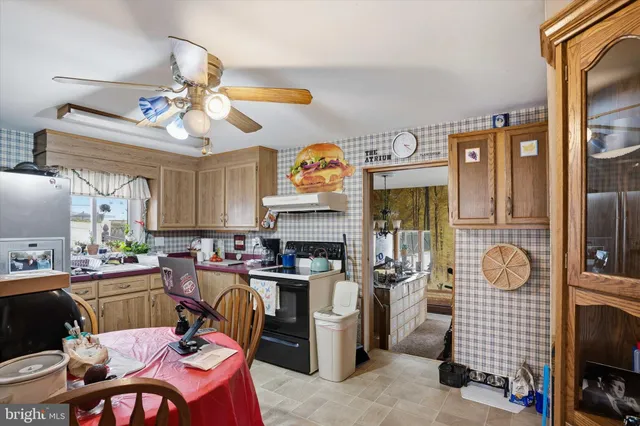a view of a dining room with furniture a chandelier and wooden floor