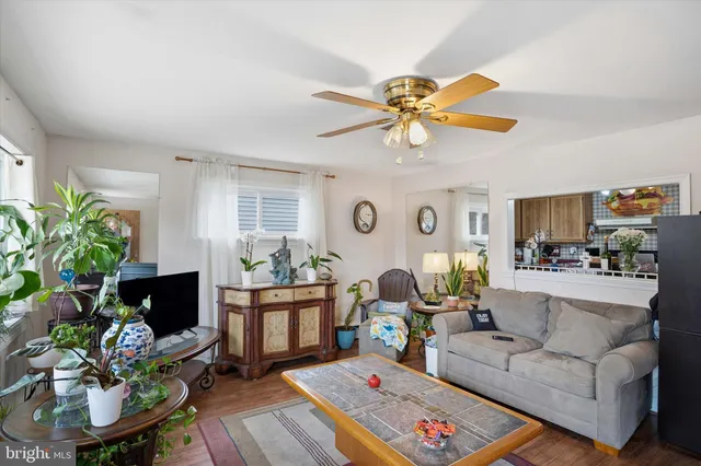 a living room with furniture a chandelier and a fireplace