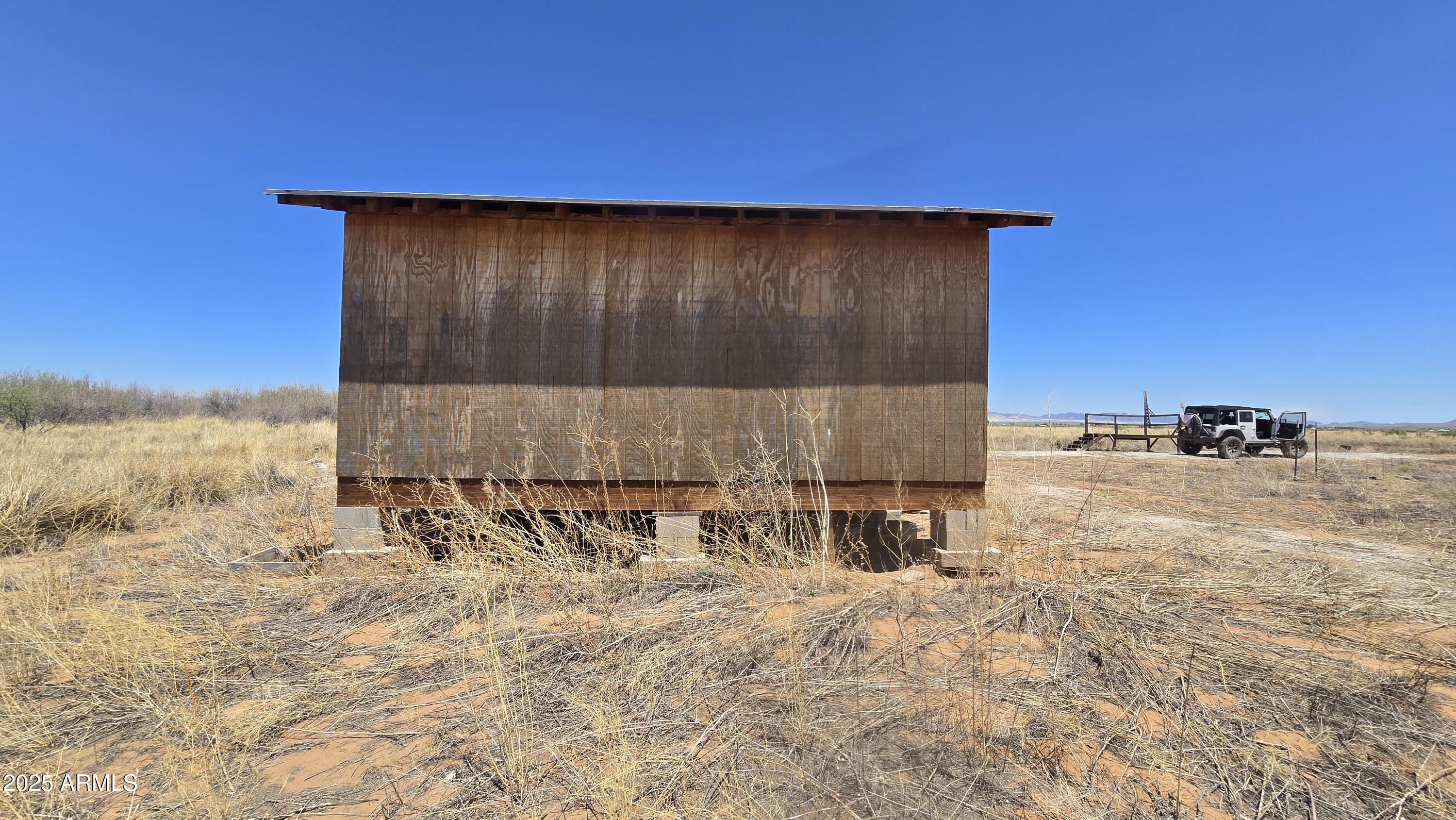 9.97-acres South Kit Carson Road, Unit 5 Pearce, AZ 85625 - Photo 11 of 22 a backyard of a house with table and chairs