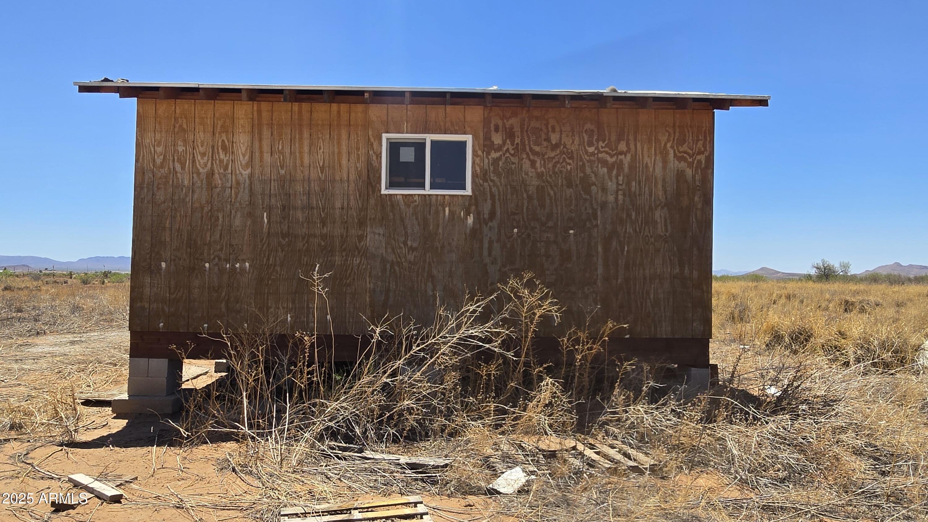 9.97-acres South Kit Carson Road, Unit 5 Pearce, AZ 85625 - Photo 8 of 22 a view of a house with a yard
