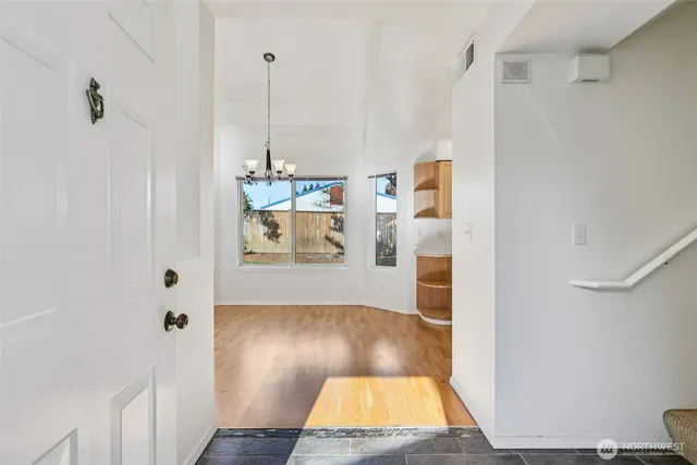 a view of hallway with wooden floor