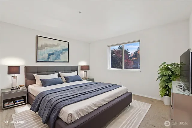 a bedroom with bed and wall painting