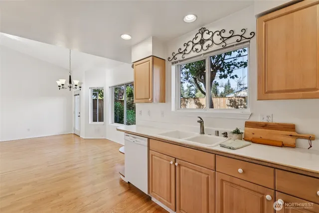 a kitchen with granite countertop a sink stainless steel appliances and cabinets