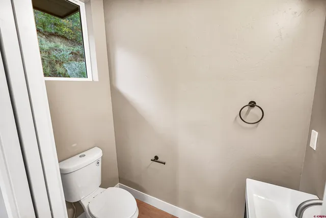 a white toilet sitting next to a shower