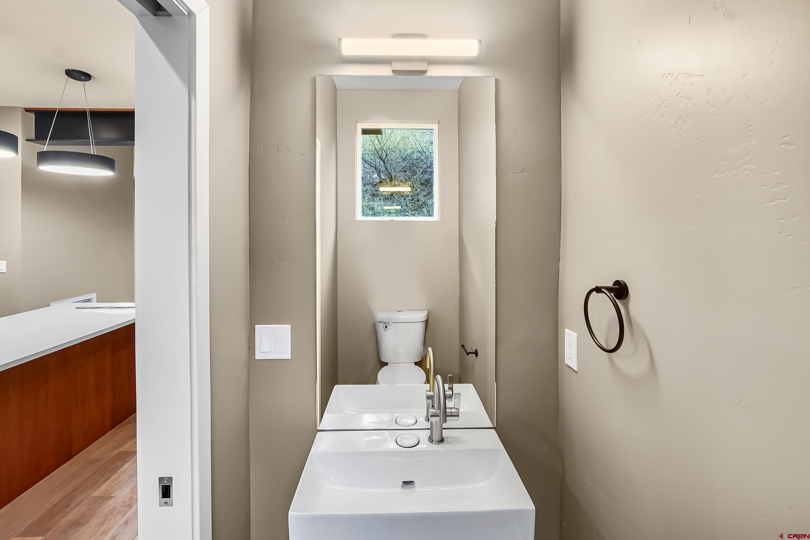 762 Goeglein Gulch Road, Unit 5 Durango, CO 81301 - Photo 12 of 43 a bathroom with a granite countertop sink a toilet and shower