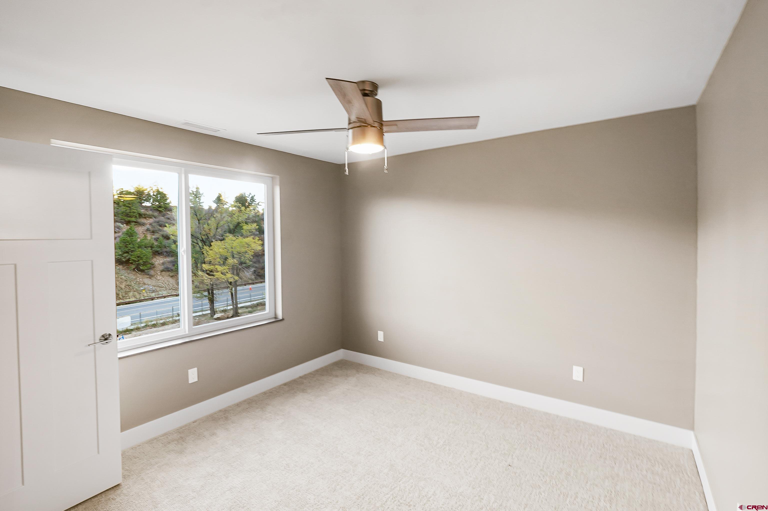 762 Goeglein Gulch Road, Unit 5 Durango, CO 81301 - Photo 20 of 43 a view of an empty room with a window