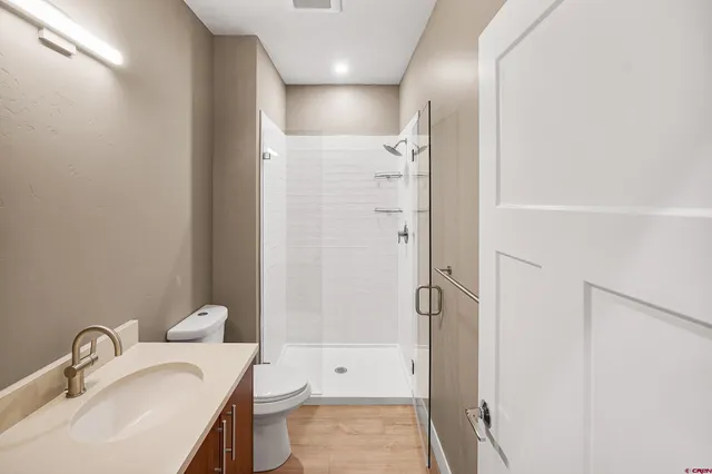 a bathroom with a sink toilet and shower