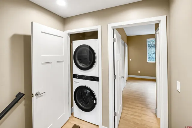 a view of a hallway with washer and dryer