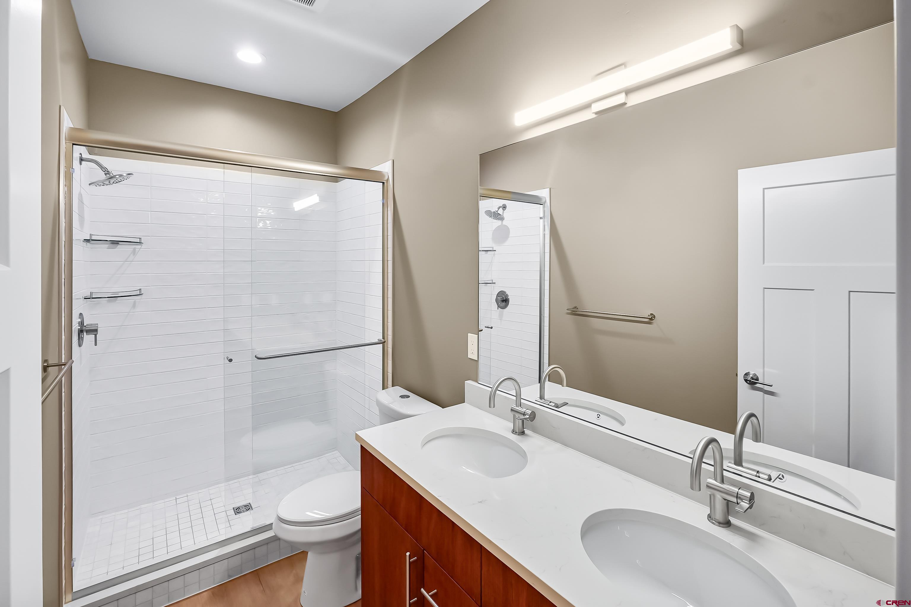 762 Goeglein Gulch Road, Unit 5 Durango, CO 81301 - Photo 26 of 43 a bathroom with a sink toilet a mirror and shower