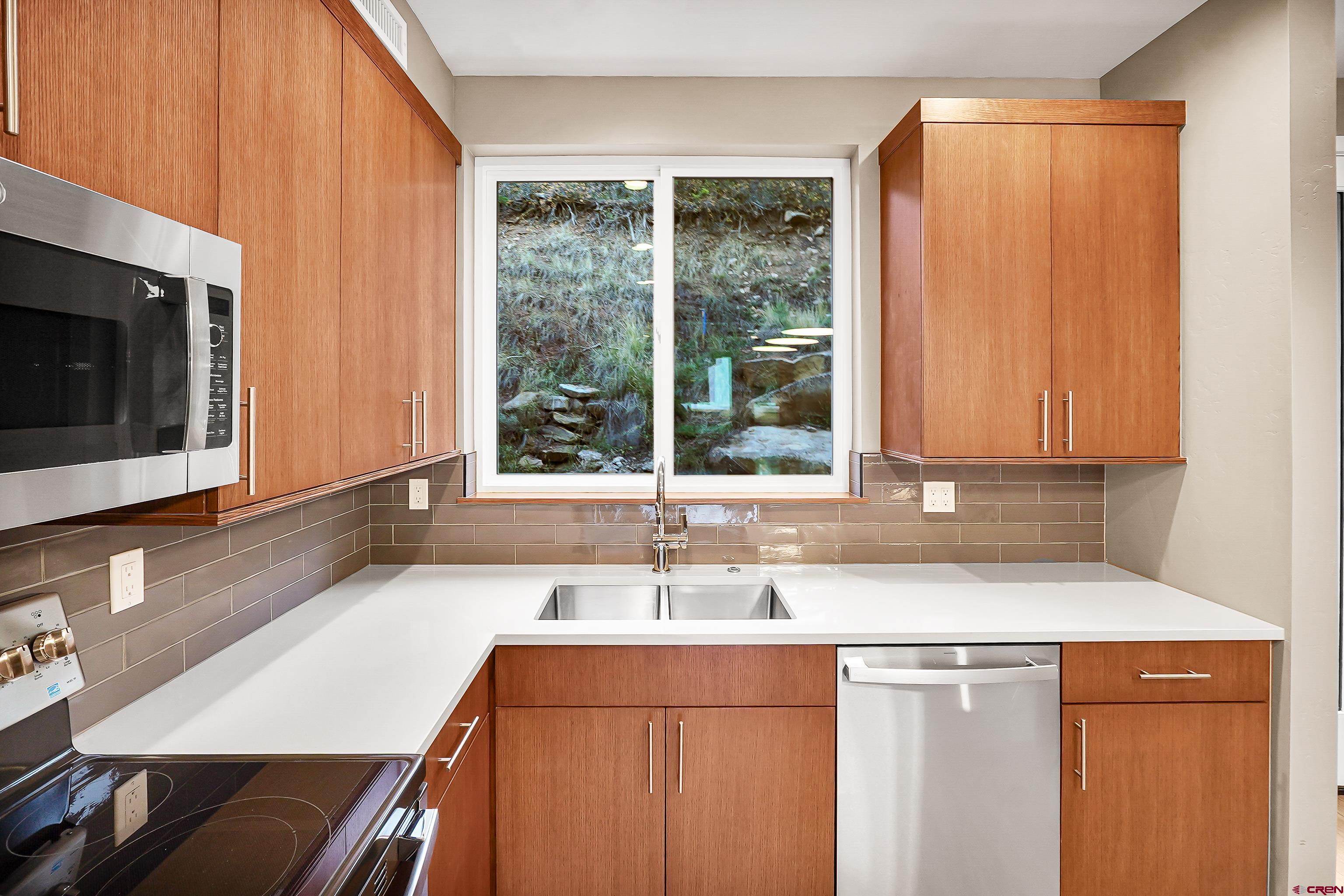 762 Goeglein Gulch Road, Unit 5 Durango, CO 81301 - Photo 7 of 43 a kitchen with a sink and a window