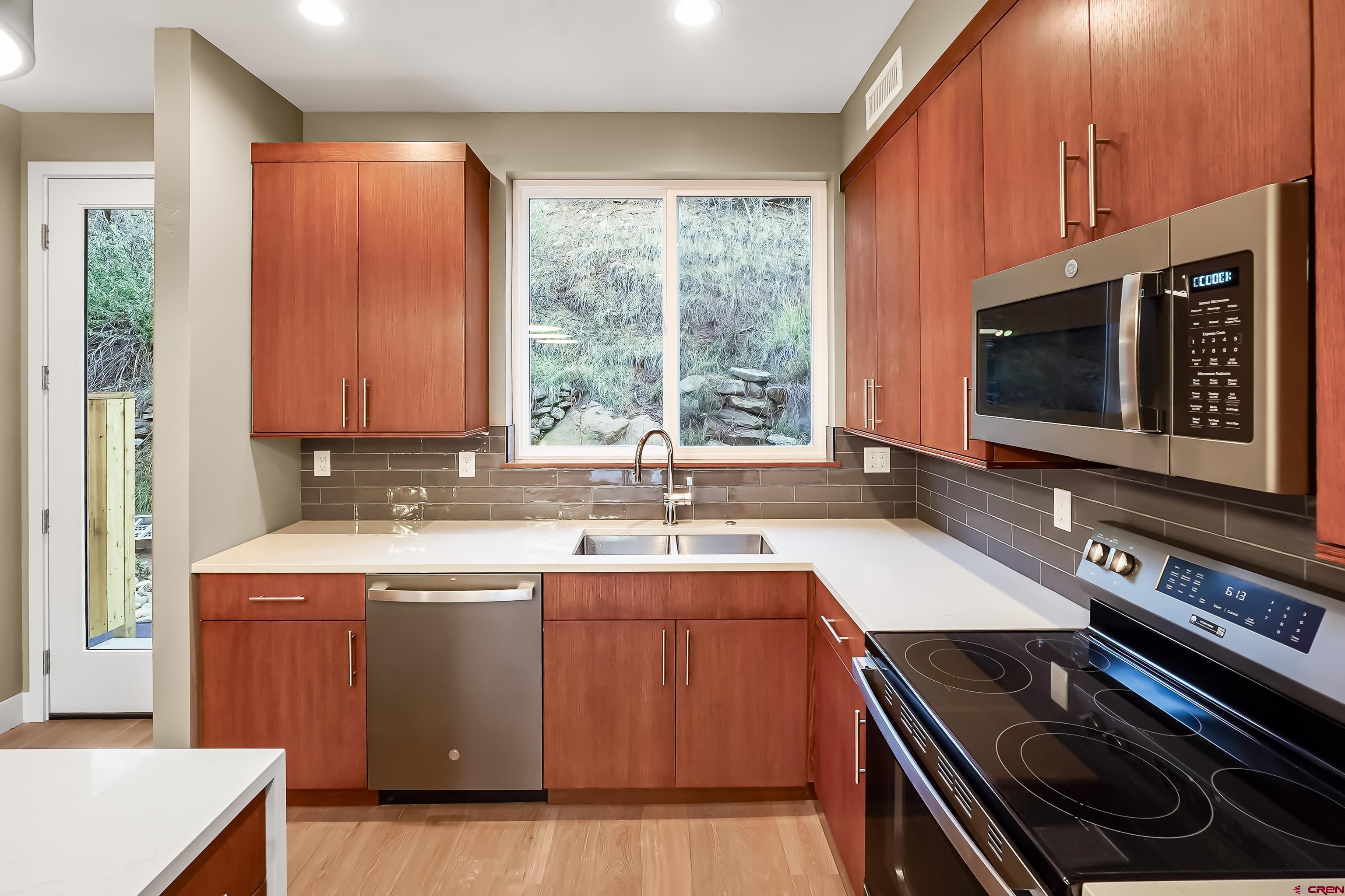 762 Goeglein Gulch Road, Unit 5 Durango, CO 81301 - Photo 10 of 43 a kitchen with a sink stove top oven and cabinets