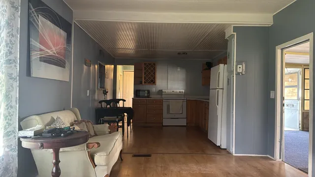 a kitchen with stainless steel appliances kitchen island granite countertop a refrigerator and a sink