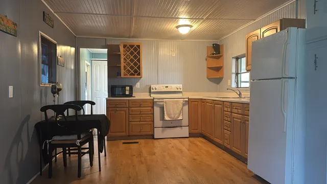 a kitchen with stainless steel appliances granite countertop a sink and cabinets