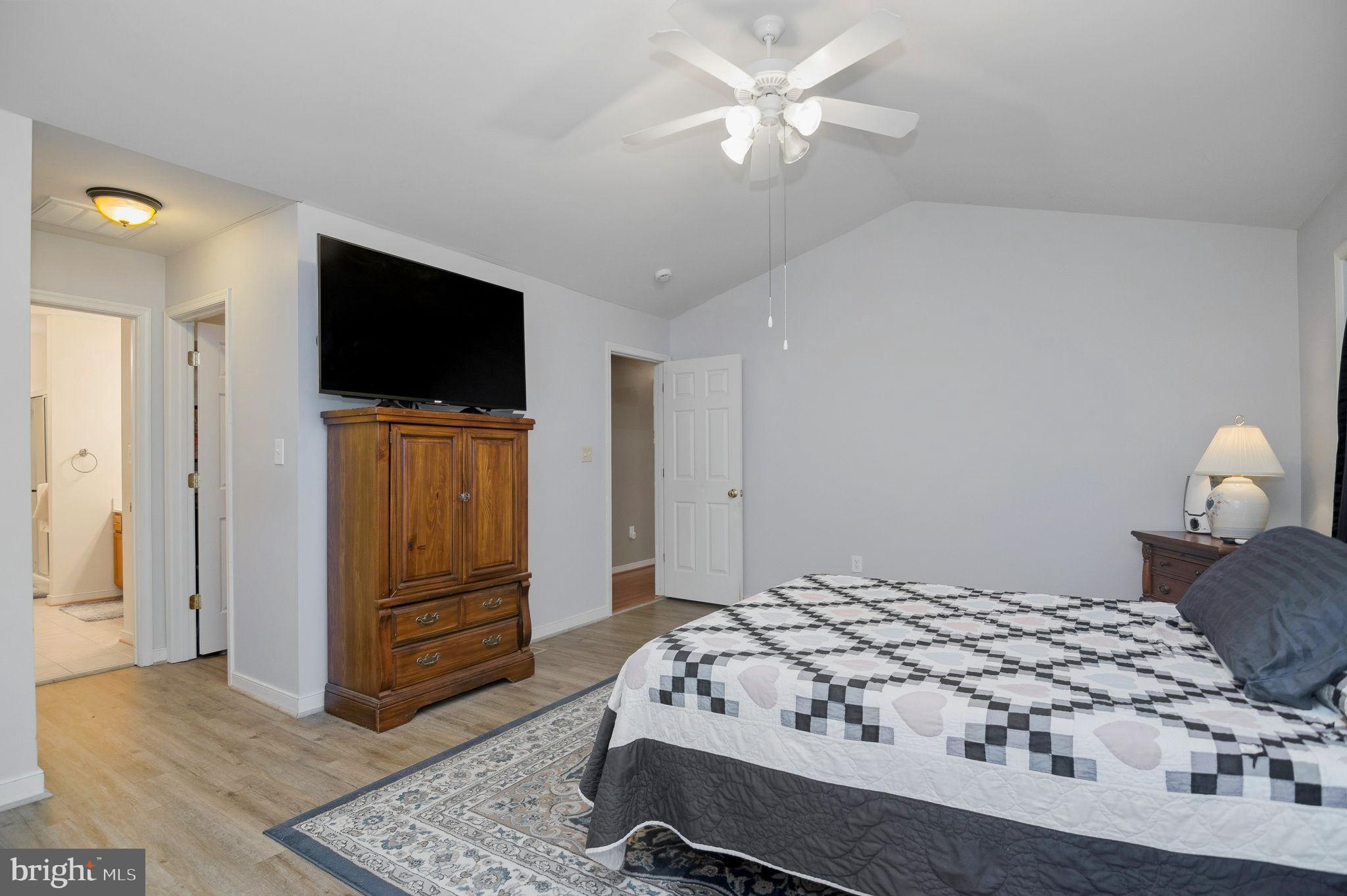 405 Harrison Circle Locust Grove, VA 22508 - Photo 16 of 33 a bedroom with a bed and a flat screen tv