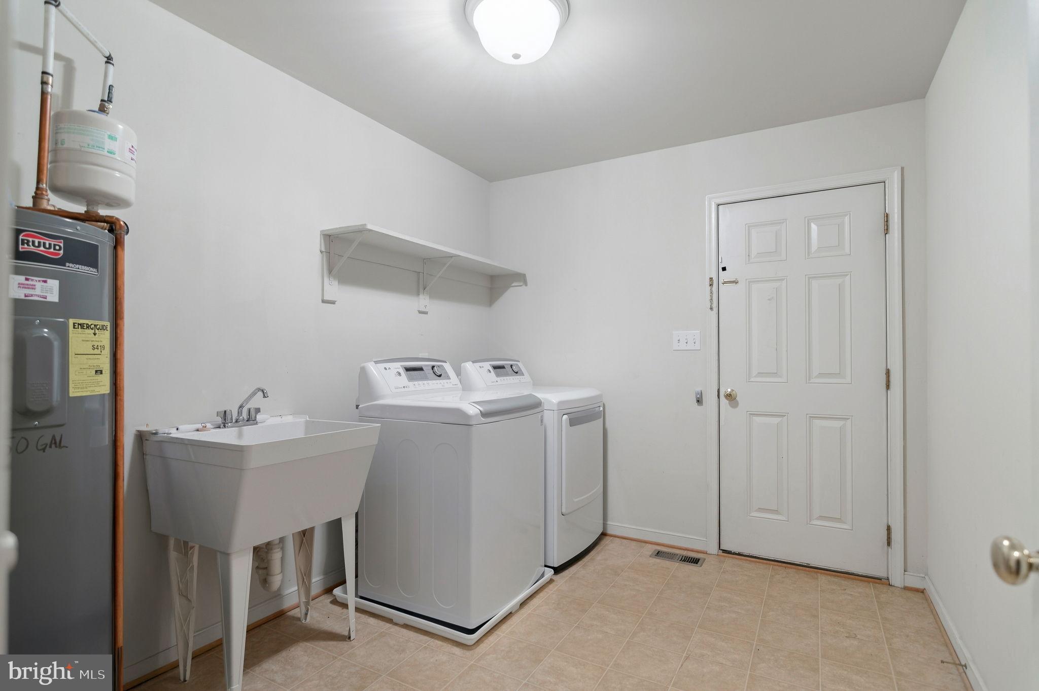 405 Harrison Circle Locust Grove, VA 22508 - Photo 28 of 33 a utility room with cabinets washer and dryer