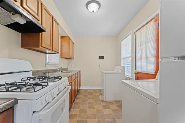a kitchen with stainless steel appliances a stove a sink and a refrigerator