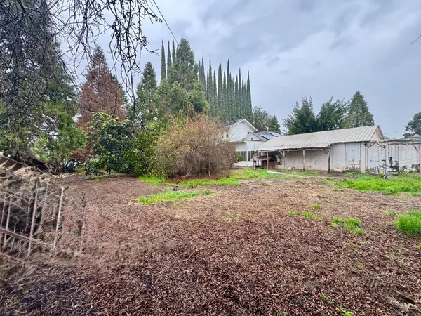 a view of a house with yard and a garden