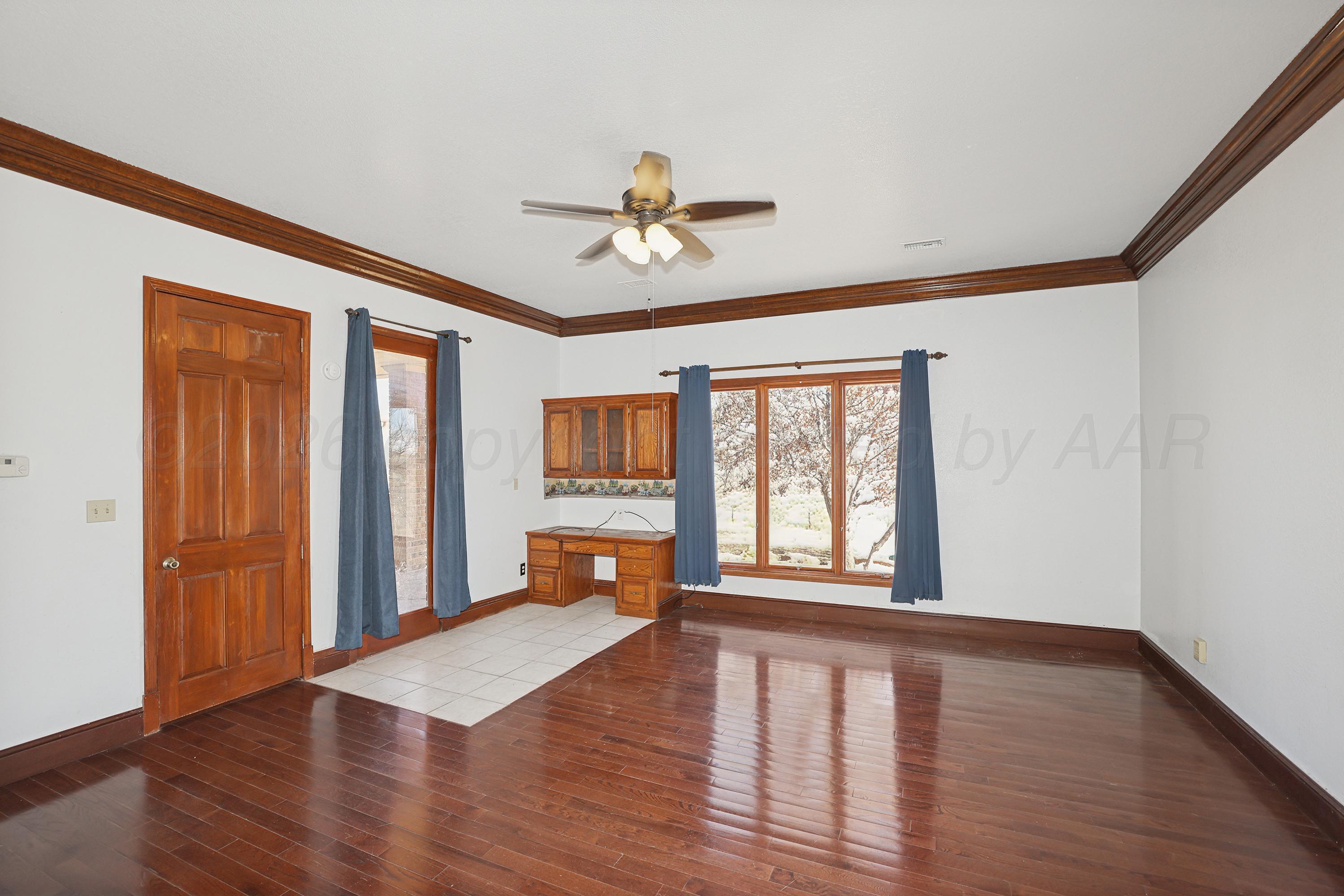 500 North Girl Scout Road Amarillo, TX 79124 - Photo 16 of 42 a view of an empty room with window and wooden floor
