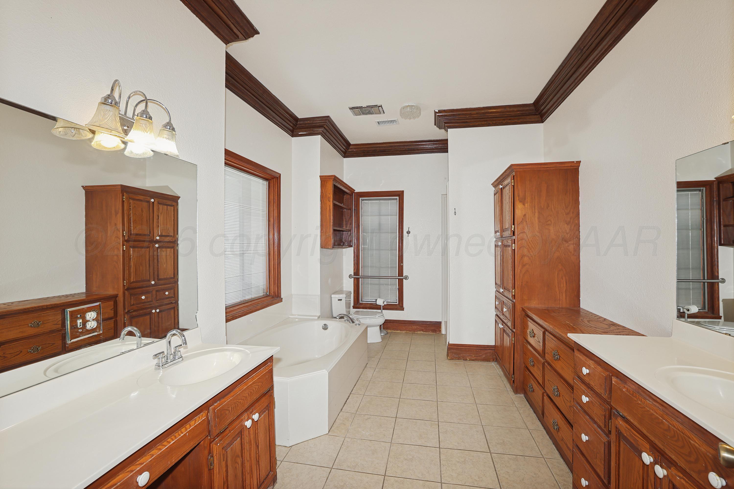 500 North Girl Scout Road Amarillo, TX 79124 - Photo 17 of 42 a large bathroom with a sink a large mirror and a shower