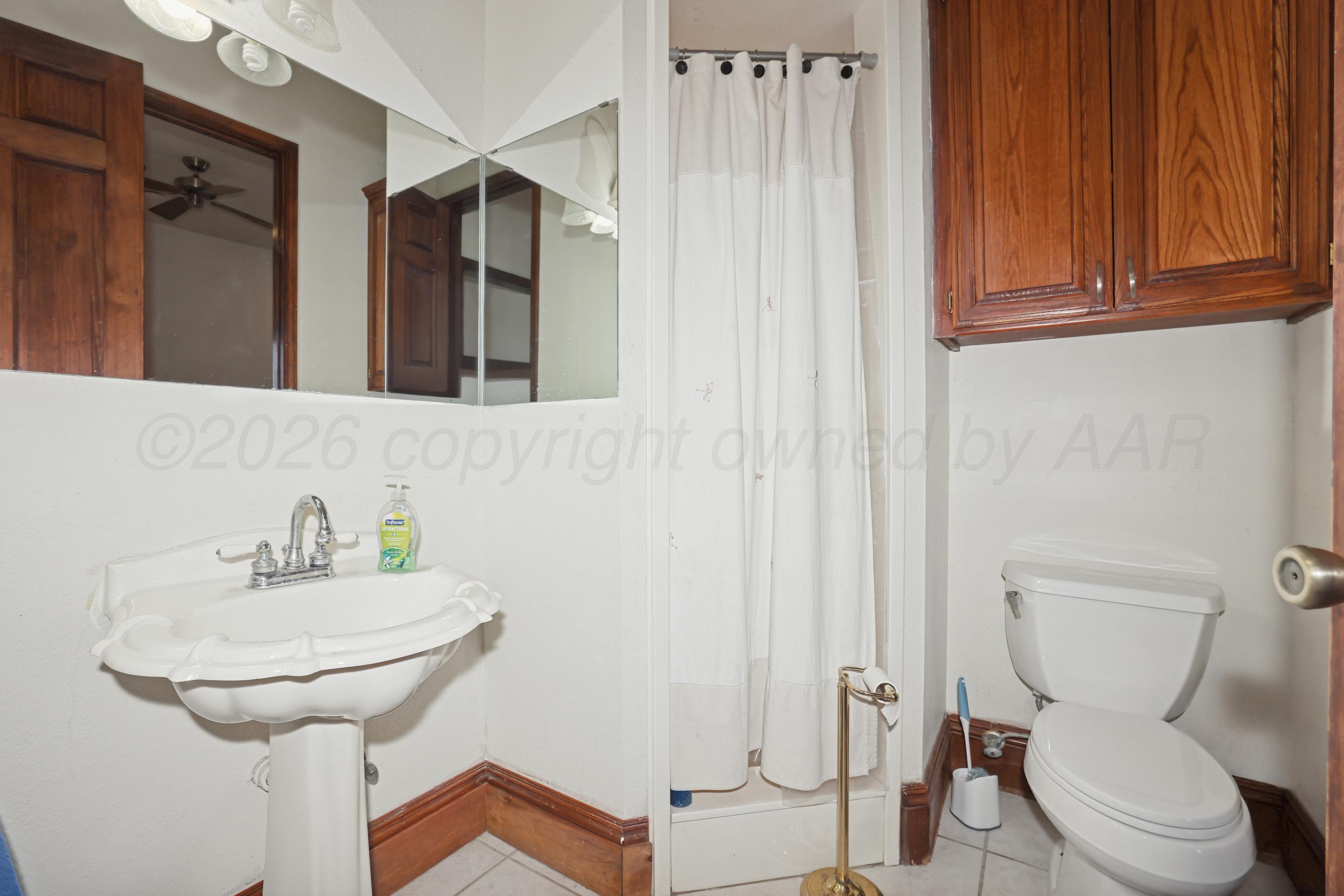 500 North Girl Scout Road Amarillo, TX 79124 - Photo 20 of 42 a bathroom with a toilet sink and mirror
