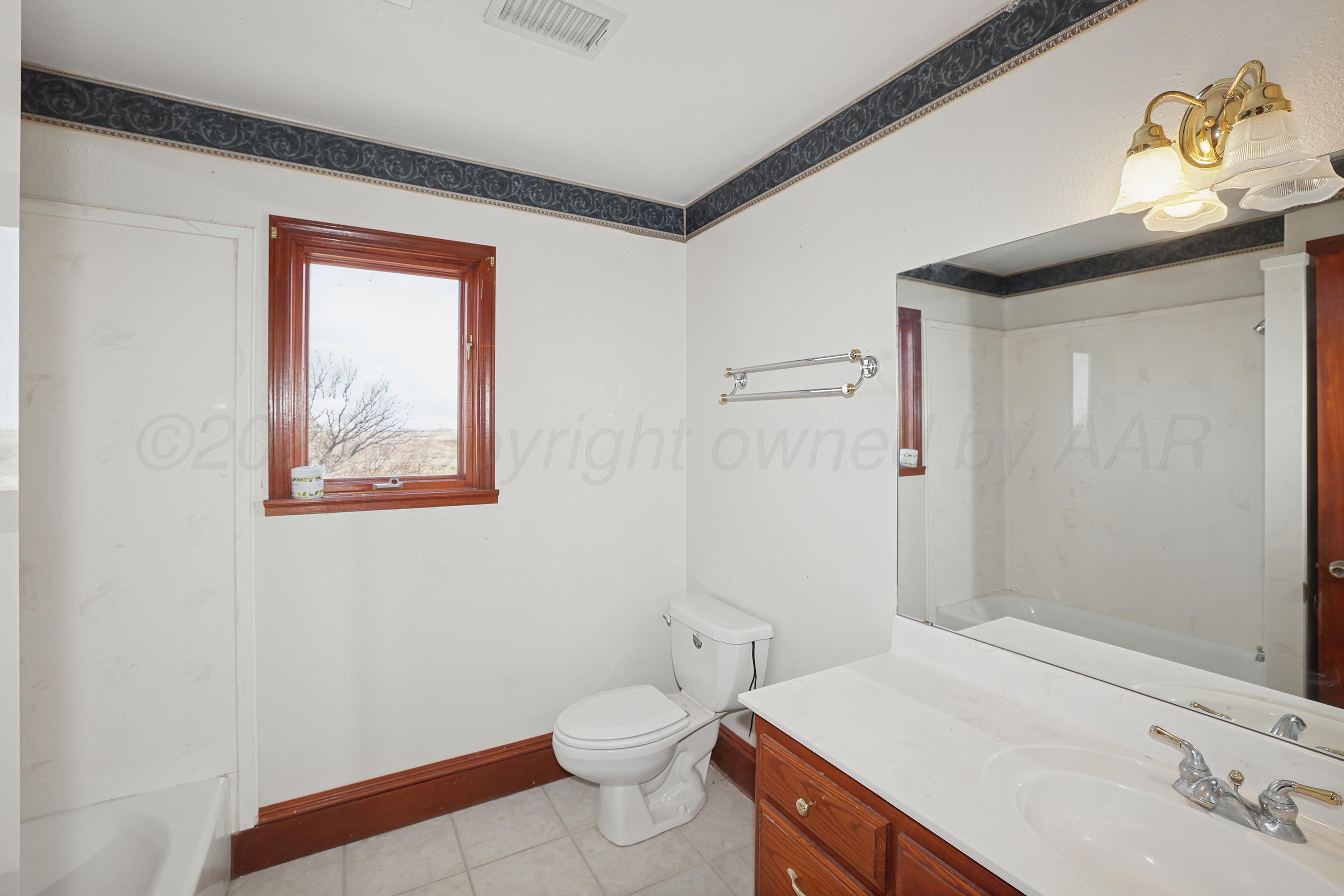 500 North Girl Scout Road Amarillo, TX 79124 - Photo 34 of 42 a bathroom with a sink a toilet and shower