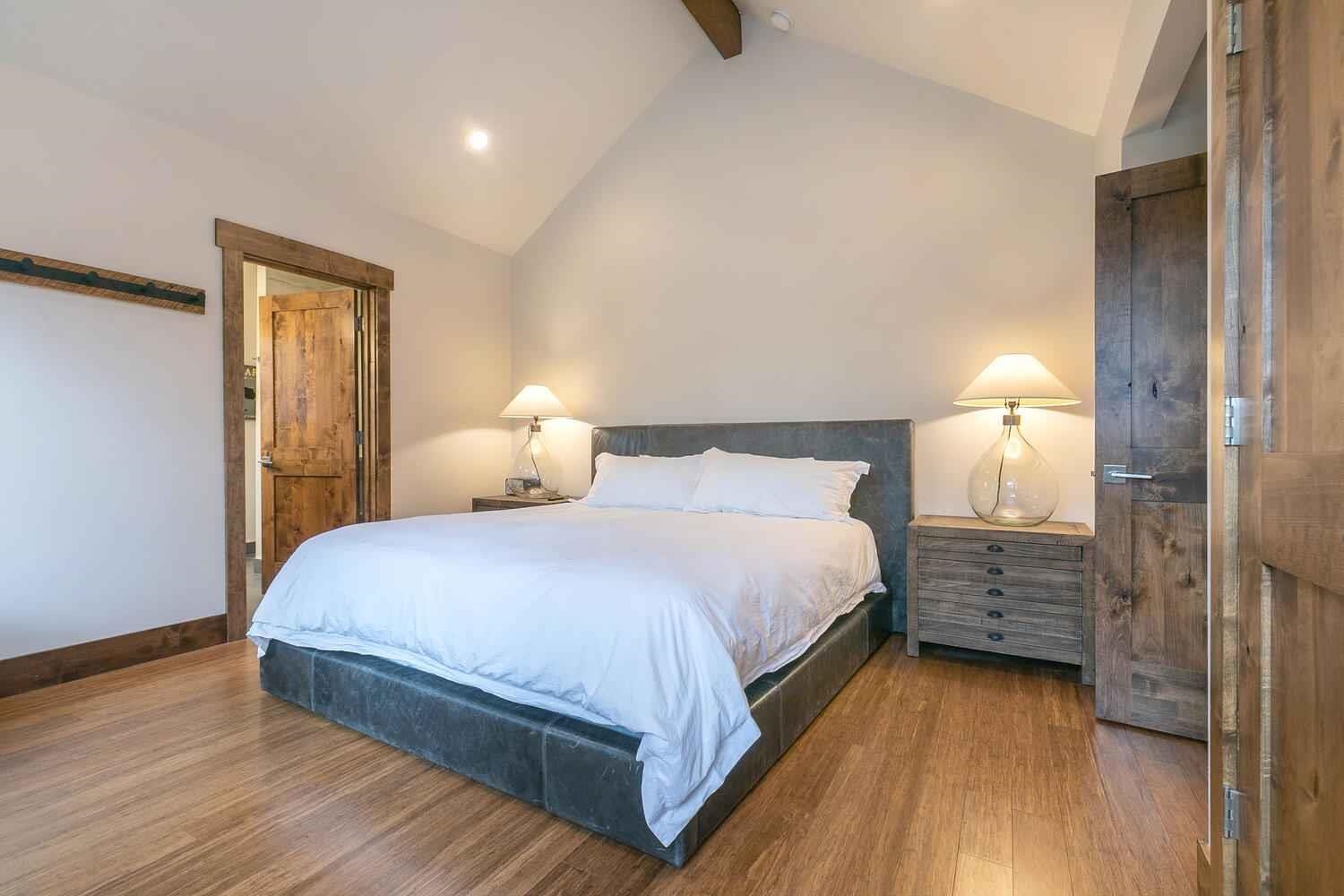 11655 Henness Road Truckee, CA 96161 - Photo 19 of 21 a bedroom with a bed and wooden floor