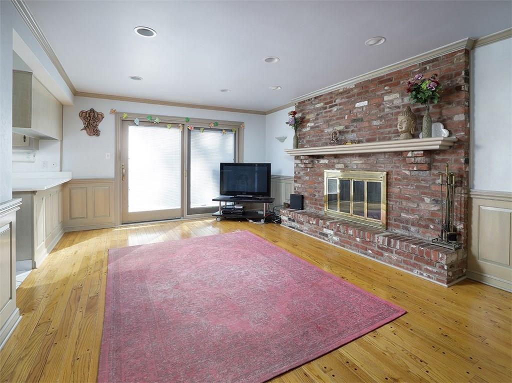 534 Harrogate Road Upper St. Clair, PA 15241 - Photo 8 of 25 Family room open to the kitchen with brick floor to ceiling fire place, hardwood flooring, Pella sliding glass door leading to the patio.