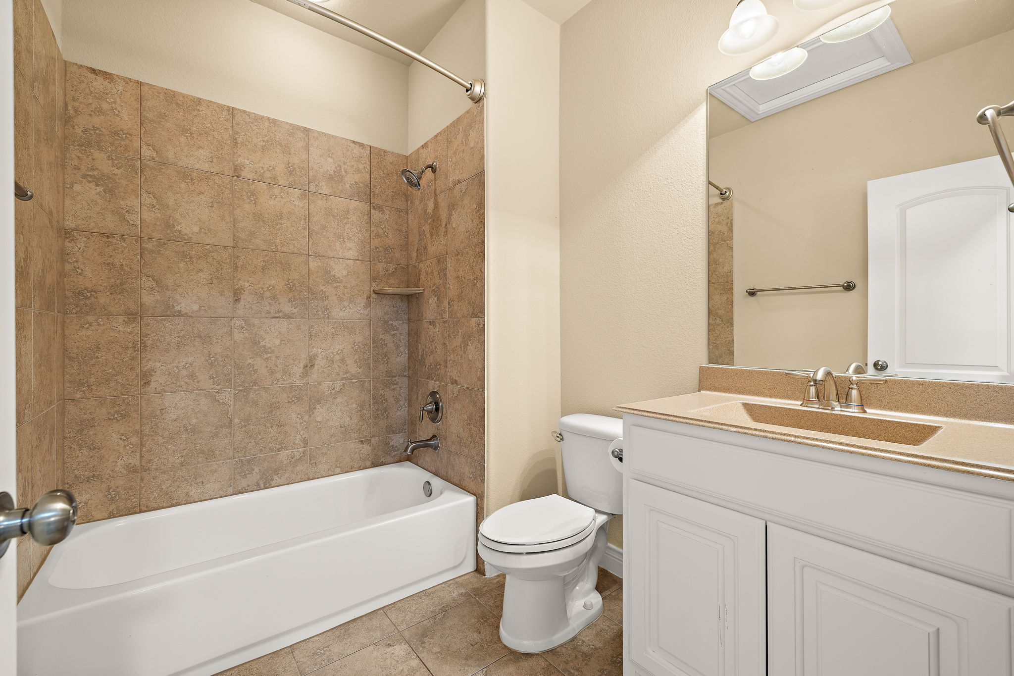 174 Estrella Crossing Georgetown, TX 78628 - Photo 28 of 38 Bathroom with shower / washtub combination, vanity, and light tile patterned floors
