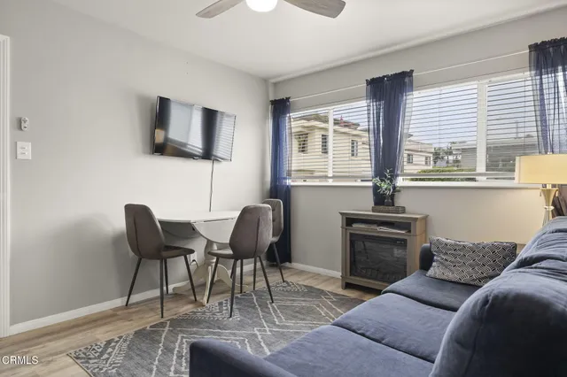 a kitchen with stainless steel appliances granite countertop a sink a stove and white cabinets